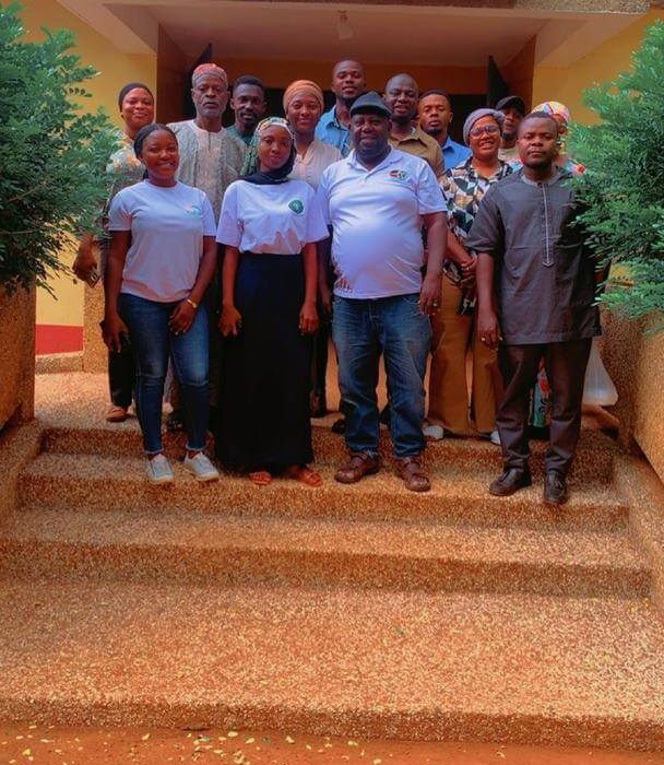 Group photograph of staff and stakeholders on the steps of a development centre